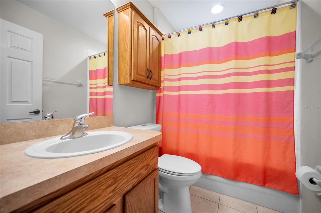 5628 Sea Turtle Court New Port Richey, FL 34652 - Photo 28 of 99 a bathroom with a sink a toilet and a mirror