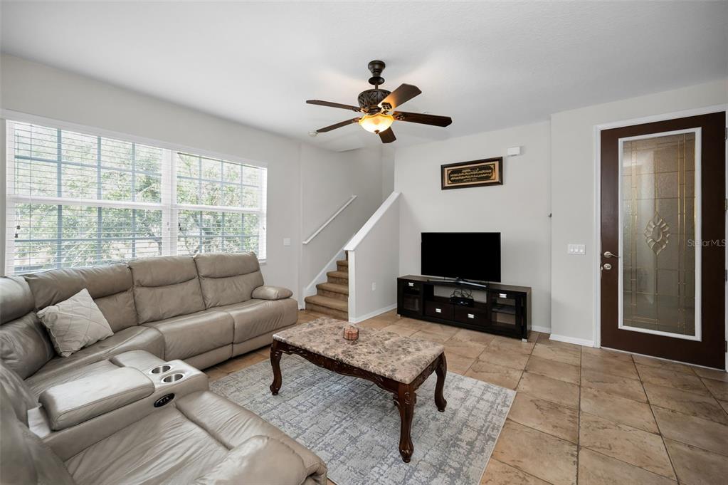 5628 Sea Turtle Court New Port Richey, FL 34652 - Photo 3 of 99 a living room with furniture and a flat screen tv