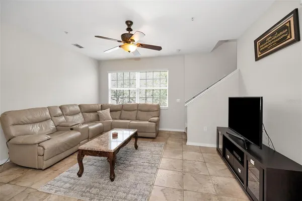 a living room with furniture and a dining table