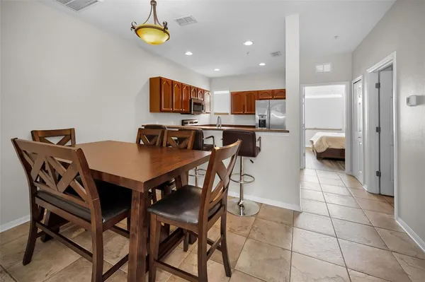 a kitchen with stainless steel appliances granite countertop a stove a sink a microwave a refrigerator and cabinets