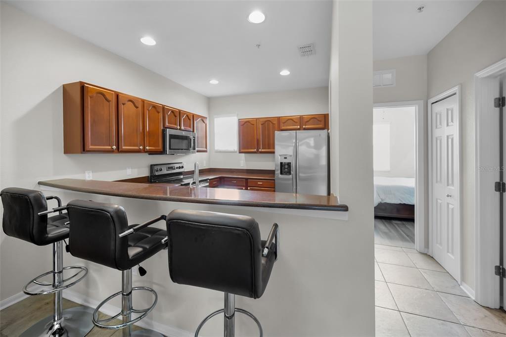 5628 Sea Turtle Court New Port Richey, FL 34652 - Photo 10 of 99 a kitchen with stainless steel appliances granite countertop a stove a sink a microwave a refrigerator and cabinets