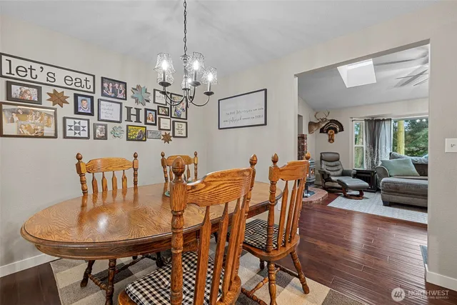 a view of a dining room with furniture wooden floor and chandelier