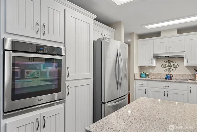 a kitchen with stainless steel appliances a refrigerator and cabinets