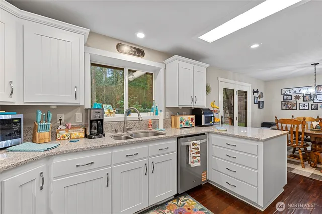 a kitchen with white cabinets and white appliances