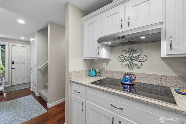 a kitchen with a refrigerator and cabinets