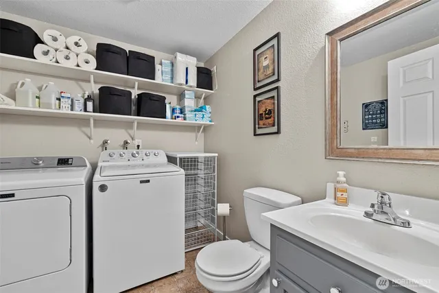 a bathroom with a toilet sink and mirror