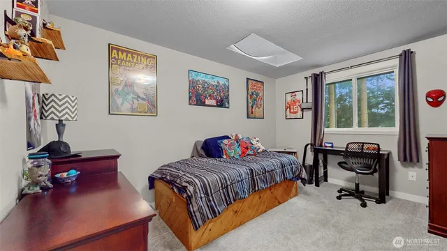 a bedroom with bed and a window