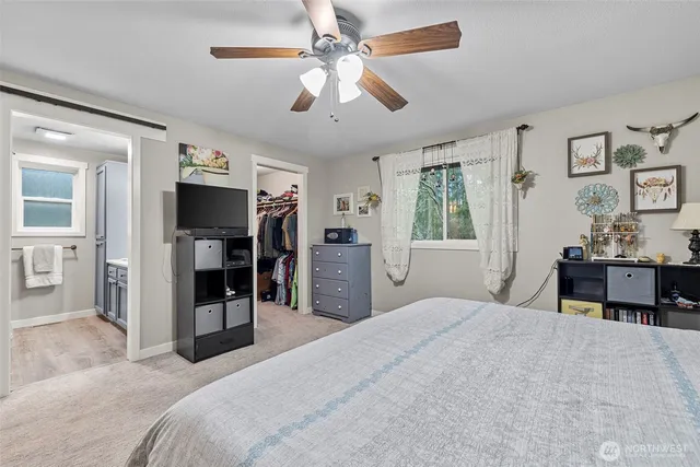 a bedroom with a large bed and a chandelier