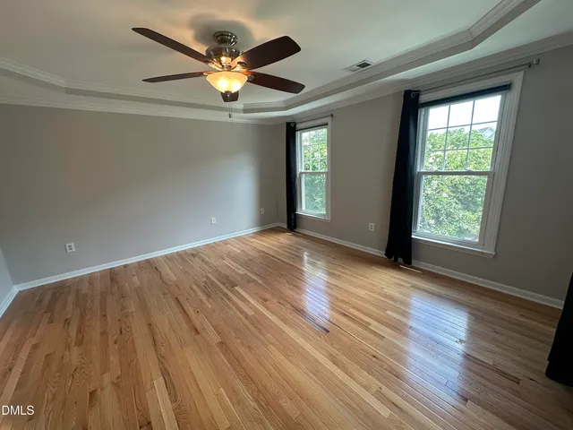 a spacious bathroom with a tub sink and mirror