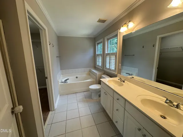 wooden view of a hallway with wooden floor and closet area