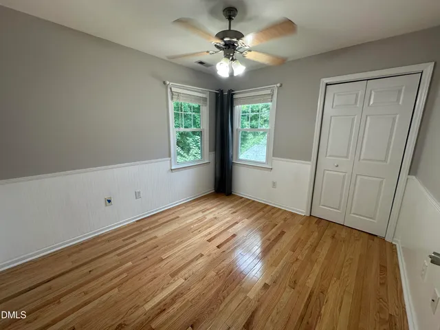a bathroom with a bathtub shower sink mirror vanity and toilet