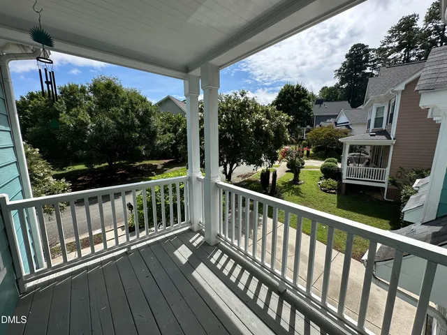a view of balcony with wooden floor and fence