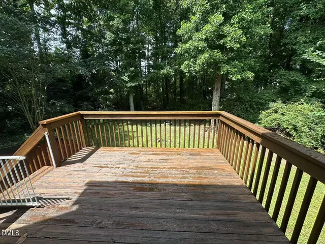 a view of balcony with wooden floor and fence