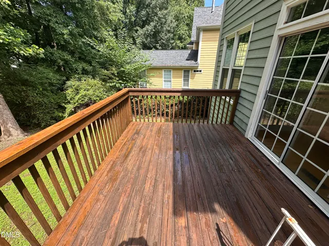 a view of a house with a yard and a large tree