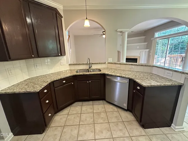 a kitchen with a stove sink and cabinets