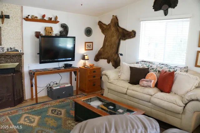 a living room with fireplace furniture and a flat screen tv