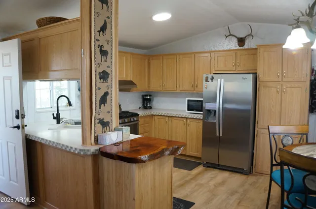 a kitchen with stainless steel appliances a stove a sink and a microwave