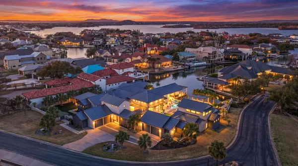 an aerial view of a houses with a swimming pool