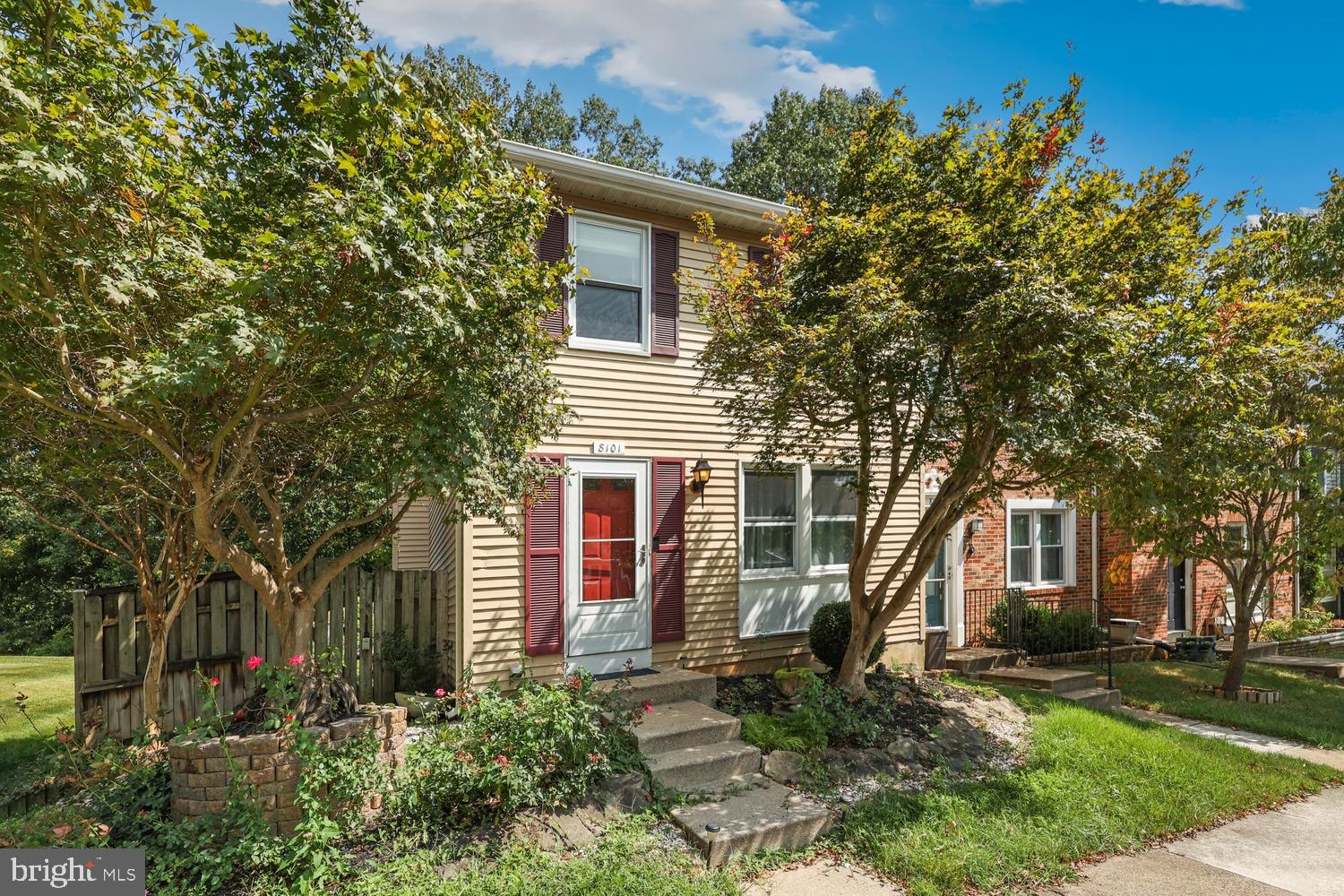 a front view of a house with a tree