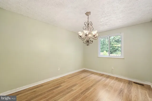 a view of a room with windows and chandelier