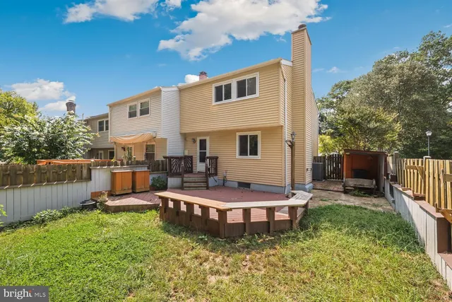 a front view of house with wooden fence
