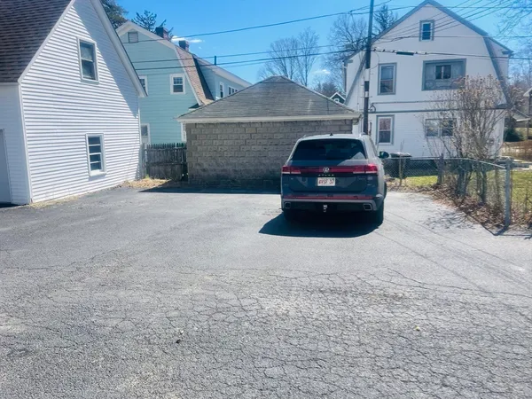a car parked in front of white house