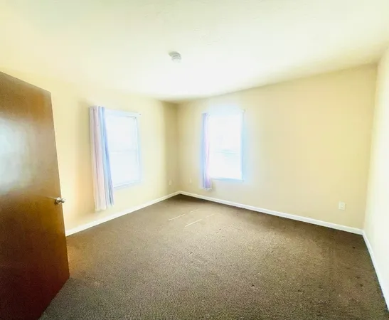 an empty room with a empty space and a window