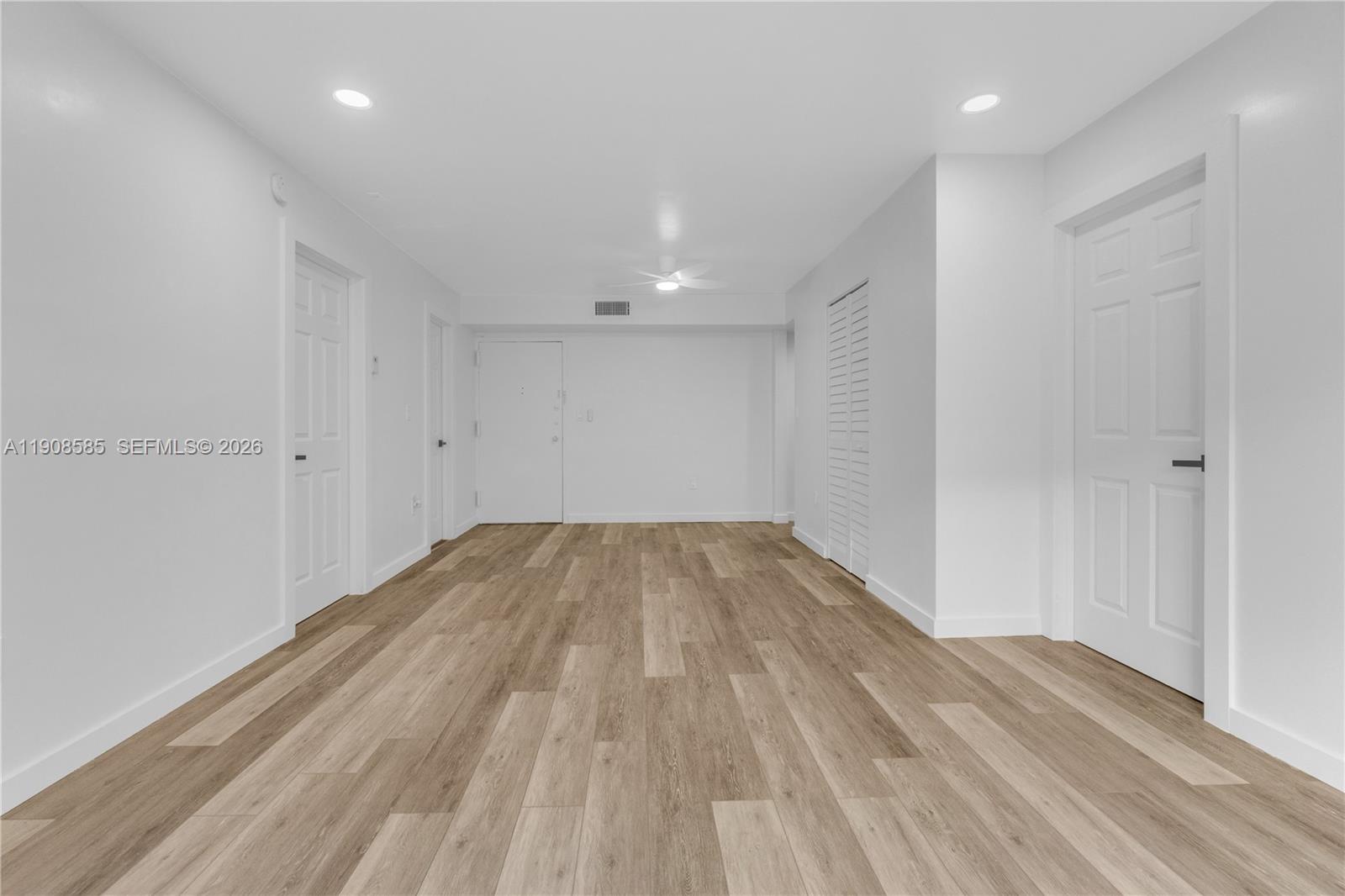 a view of empty room with wooden floor