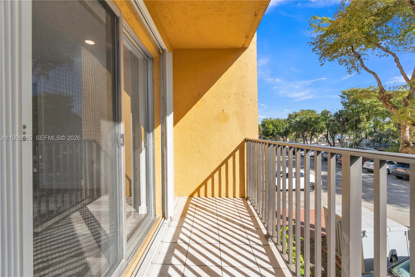 4709 Northwest 7th Street, Unit 2049 Miami, FL 33126 - Photo 23 of 51 a view of a balcony with wooden floor and fence