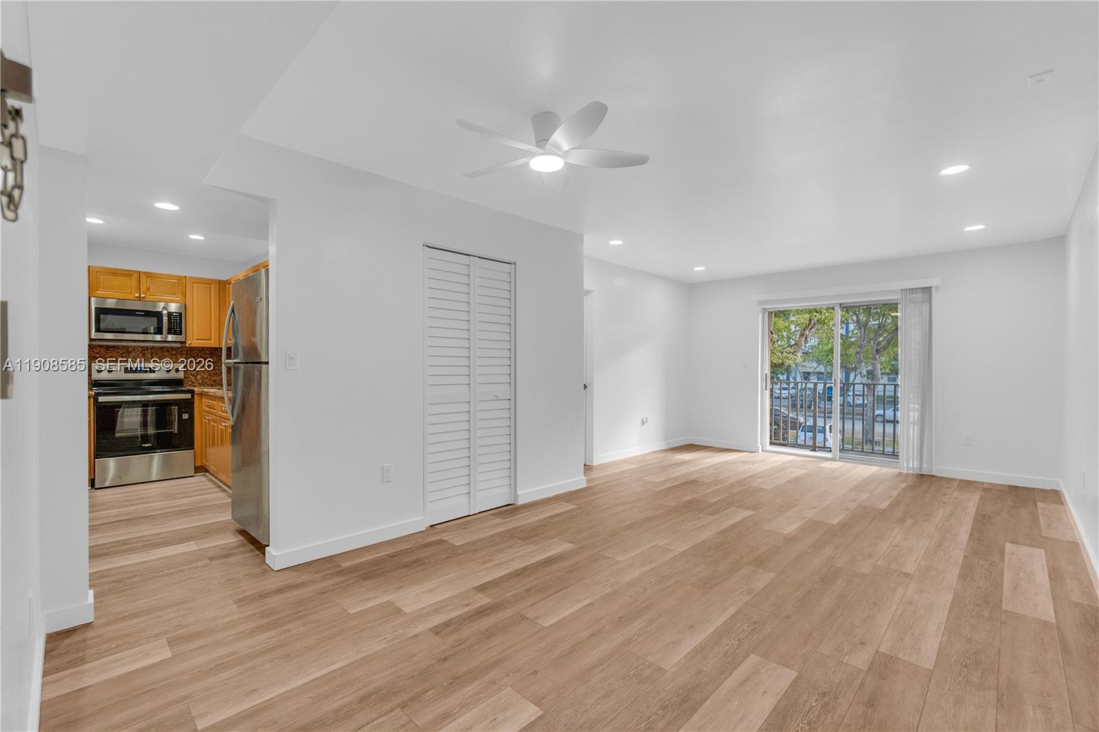 4709 Northwest 7th Street, Unit 2049 Miami, FL 33126 - Photo 30 of 51 a view of an empty room with window and wooden floor