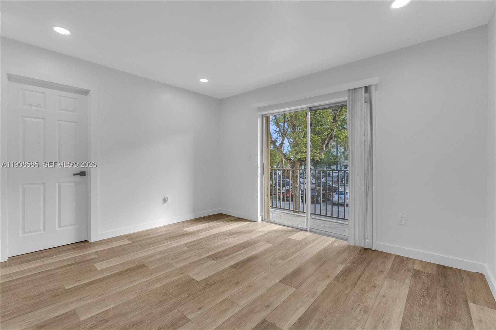 4709 Northwest 7th Street, Unit 2049 Miami, FL 33126 - Photo 34 of 51 a view of an empty room with wooden floor and a window