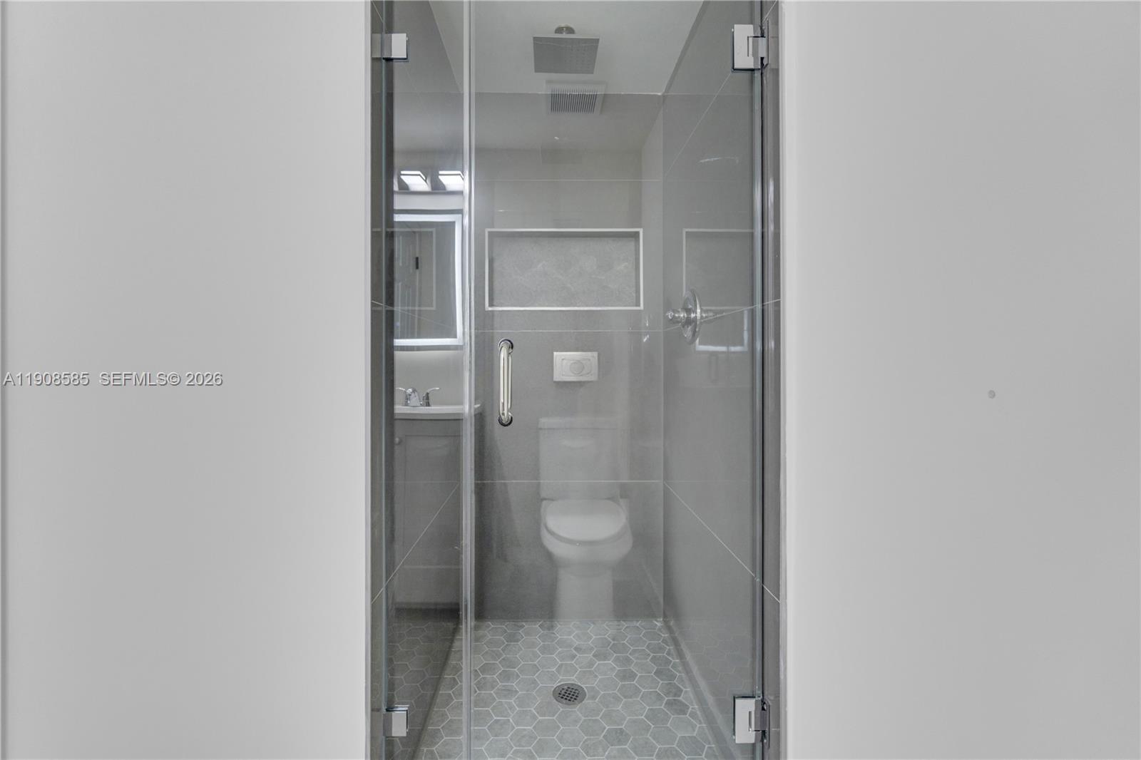 4709 Northwest 7th Street, Unit 2049 Miami, FL 33126 - Photo 35 of 51 a bathroom with a granite countertop toilet and a shower