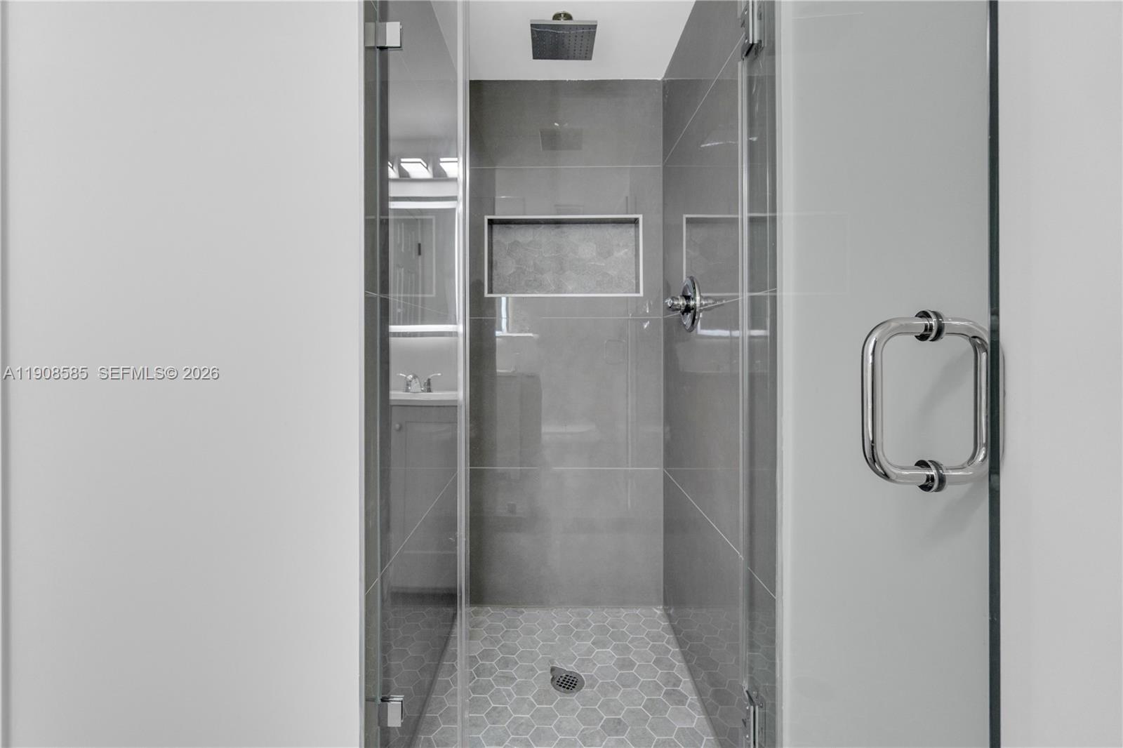 4709 Northwest 7th Street, Unit 2049 Miami, FL 33126 - Photo 36 of 51 a bathroom with a glass shower door
