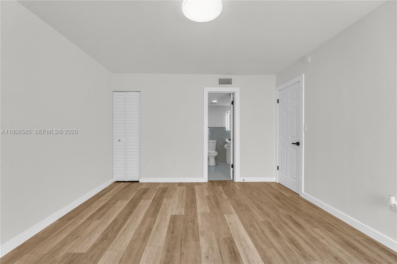 4709 Northwest 7th Street, Unit 2049 Miami, FL 33126 - Photo 47 of 51 a view of a room with wooden floor and white walls