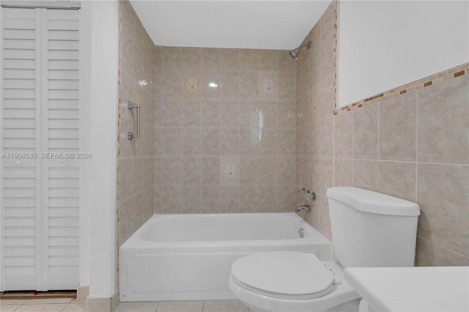 4709 Northwest 7th Street, Unit 2049 Miami, FL 33126 - Photo 50 of 51 a bathroom with a toilet and a bathtub