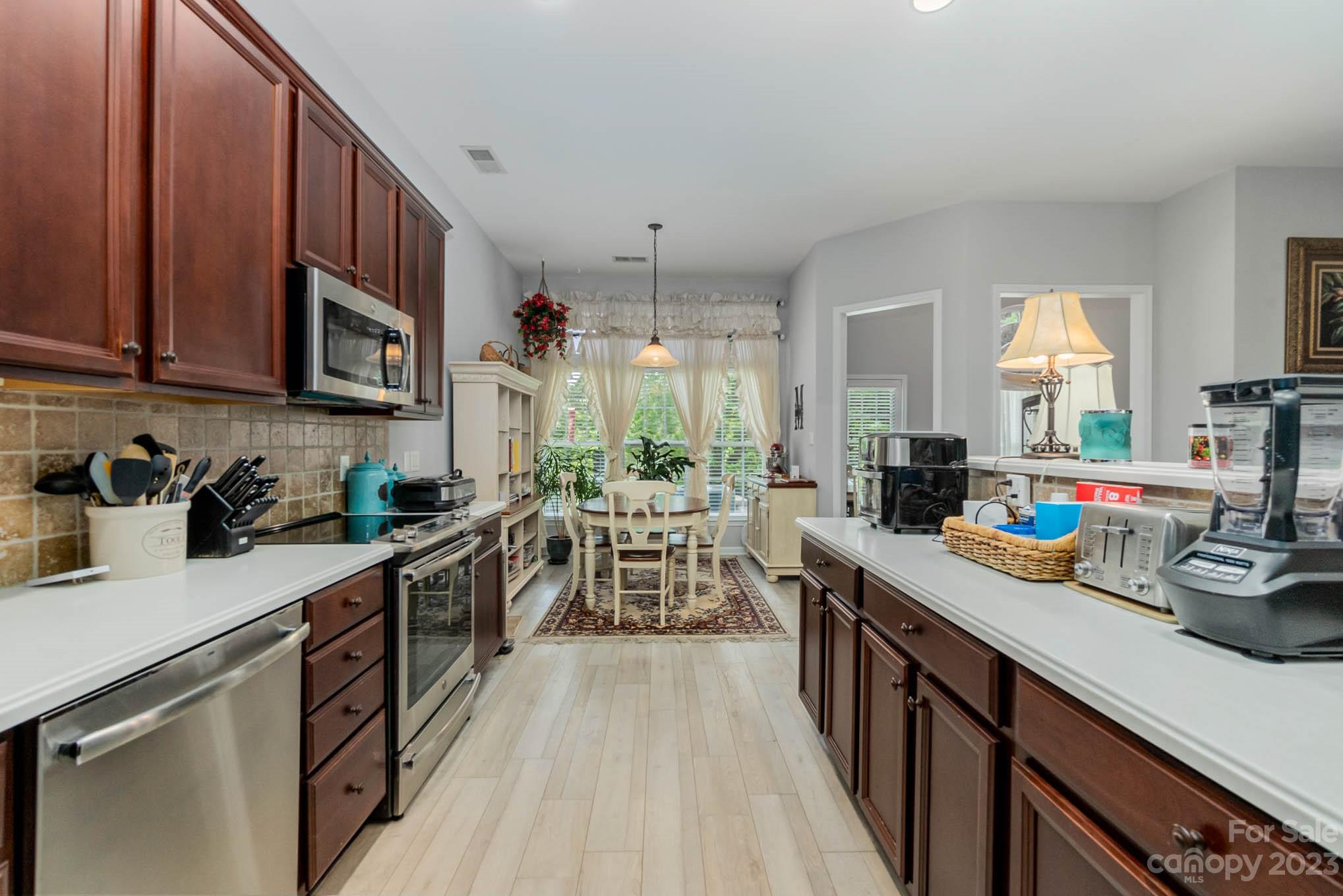 112 Pine Lake Drive Monroe, NC 28110 - Photo 15 of 37 a kitchen with stainless steel appliances granite countertop sink stove top oven and cabinets