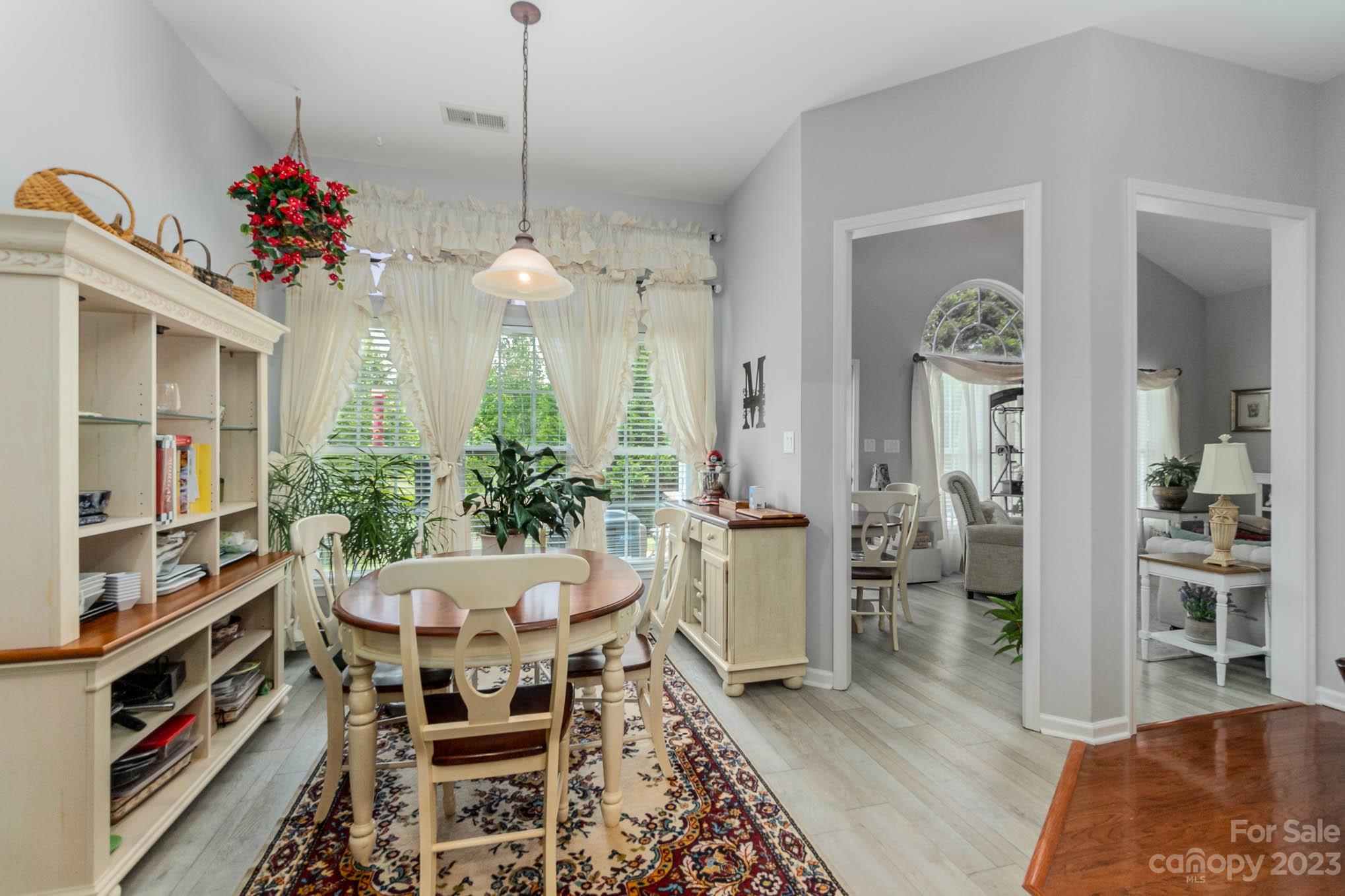 112 Pine Lake Drive Monroe, NC 28110 - Photo 16 of 37 a view of a dining room with furniture and a potted plant