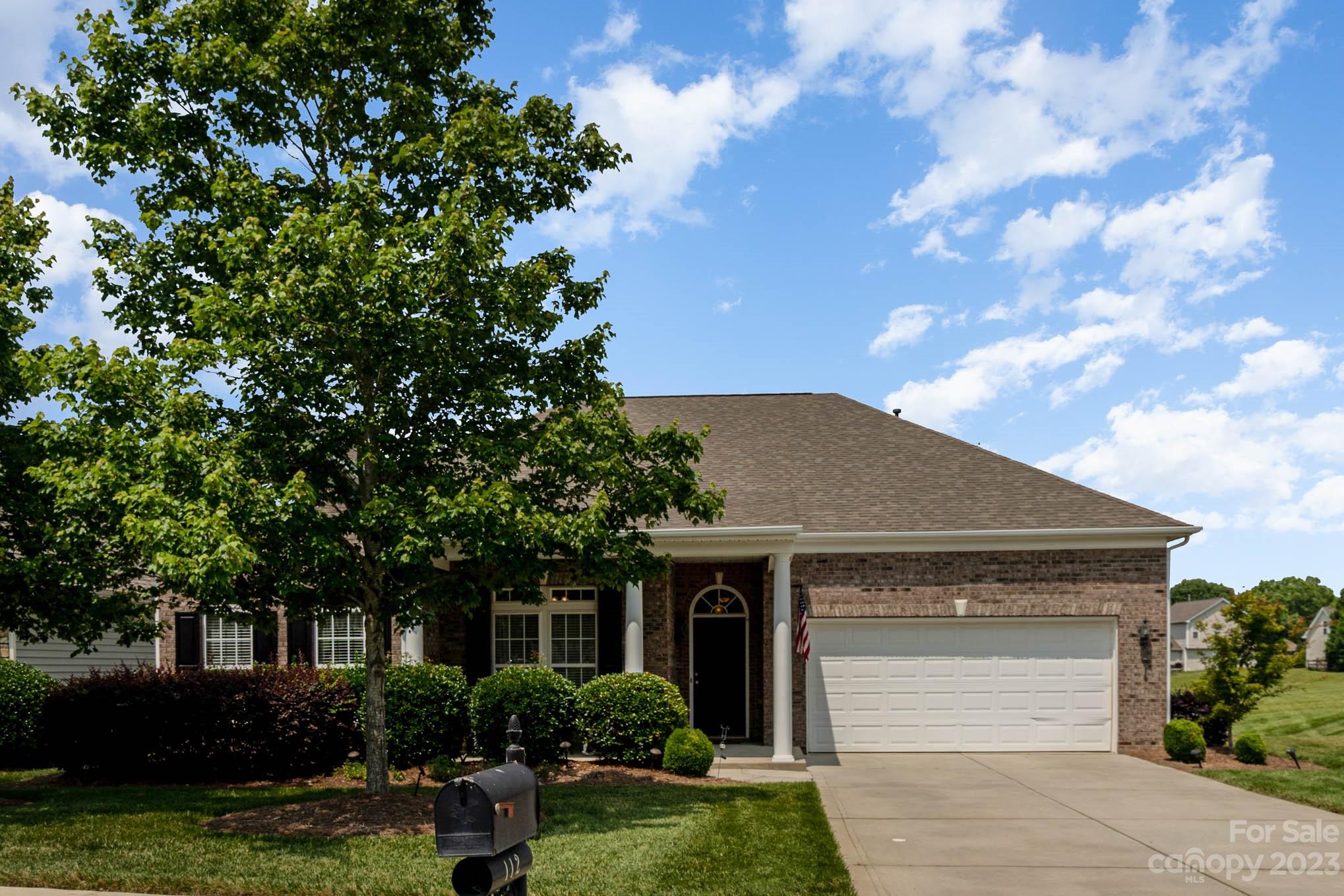 112 Pine Lake Drive Monroe, NC 28110 - Photo 2 of 37 a front view of a house with garden