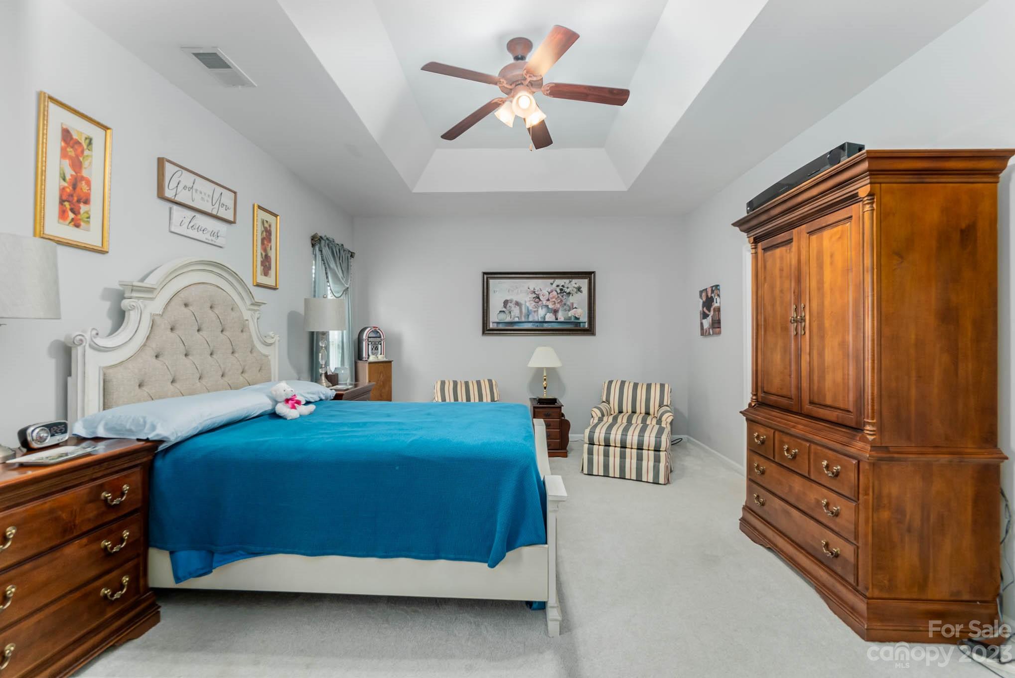 112 Pine Lake Drive Monroe, NC 28110 - Photo 21 of 37 a bedroom with a bed and a chandelier