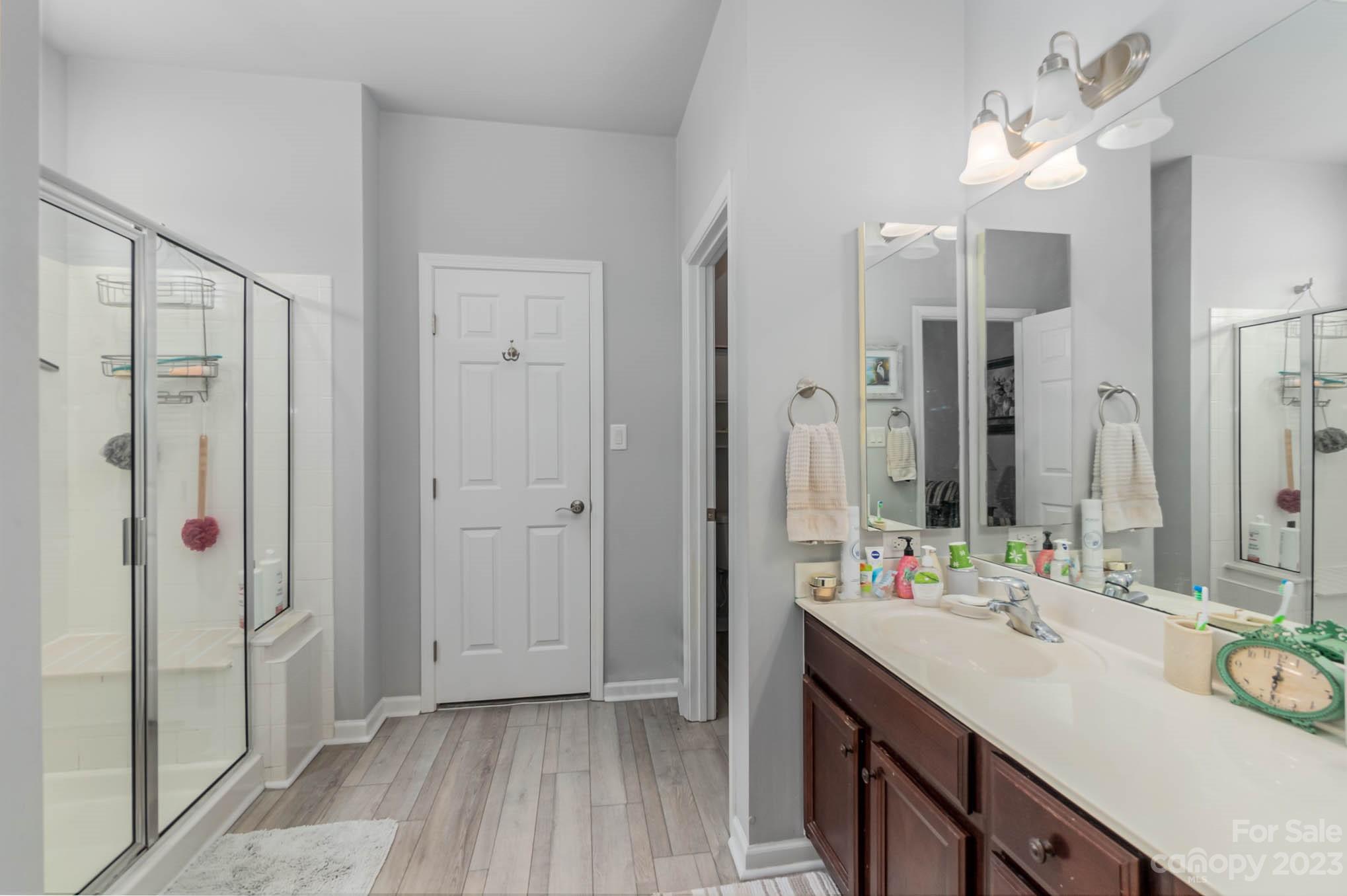 112 Pine Lake Drive Monroe, NC 28110 - Photo 23 of 37 a bathroom with a double vanity sink mirror and shower