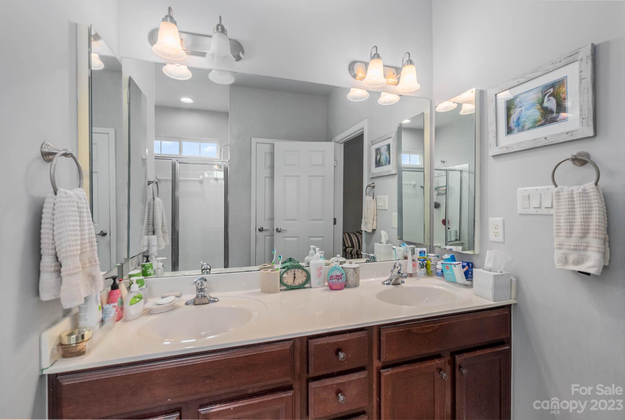 112 Pine Lake Drive Monroe, NC 28110 - Photo 25 of 37 a bathroom with a sink vanity and a mirror