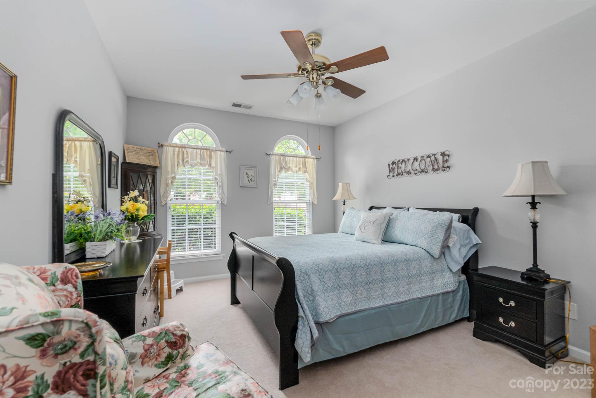 112 Pine Lake Drive Monroe, NC 28110 - Photo 27 of 37 a bedroom with a bed and large windows