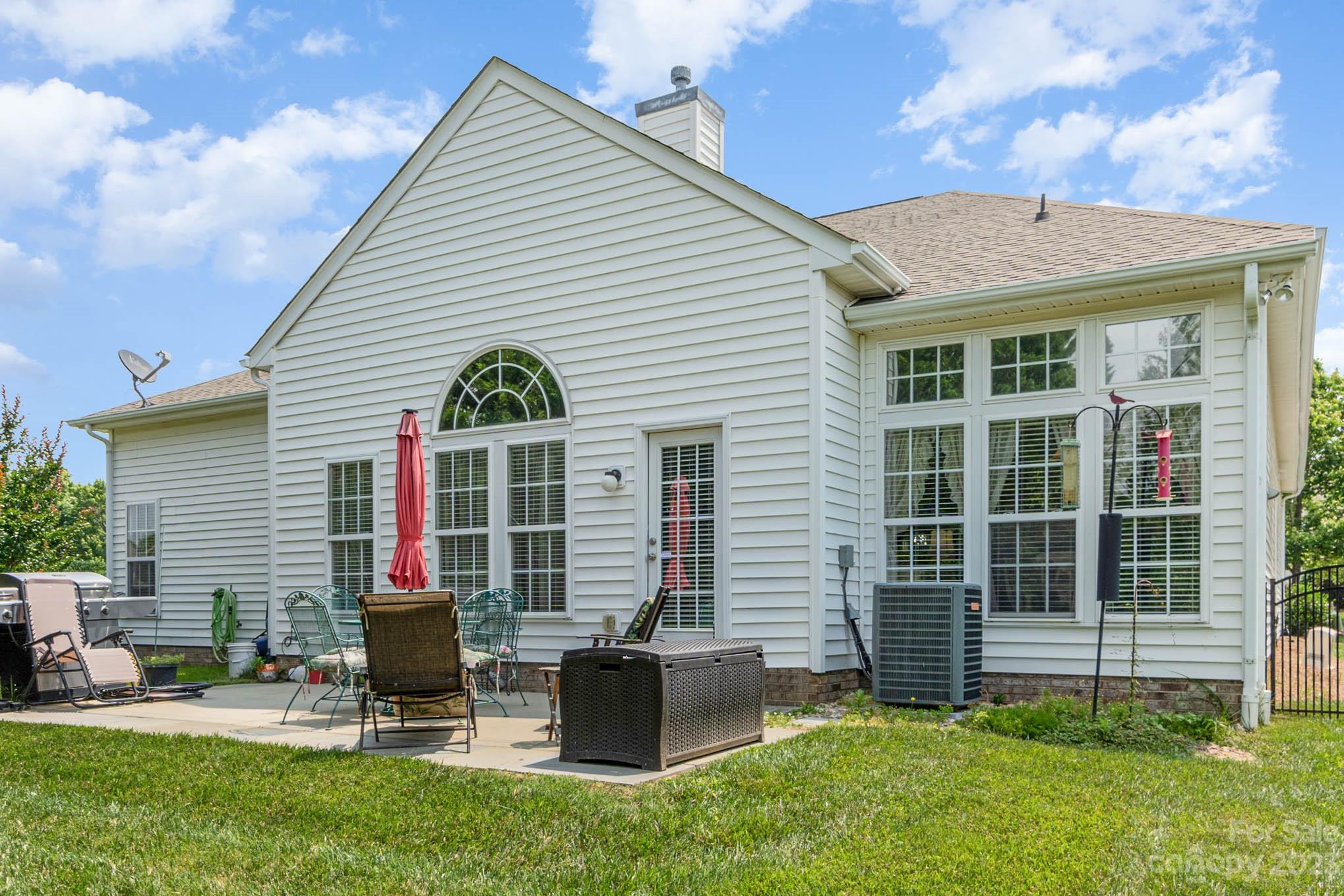112 Pine Lake Drive Monroe, NC 28110 - Photo 32 of 37 a view of backyard with table and chairs and potted plants
