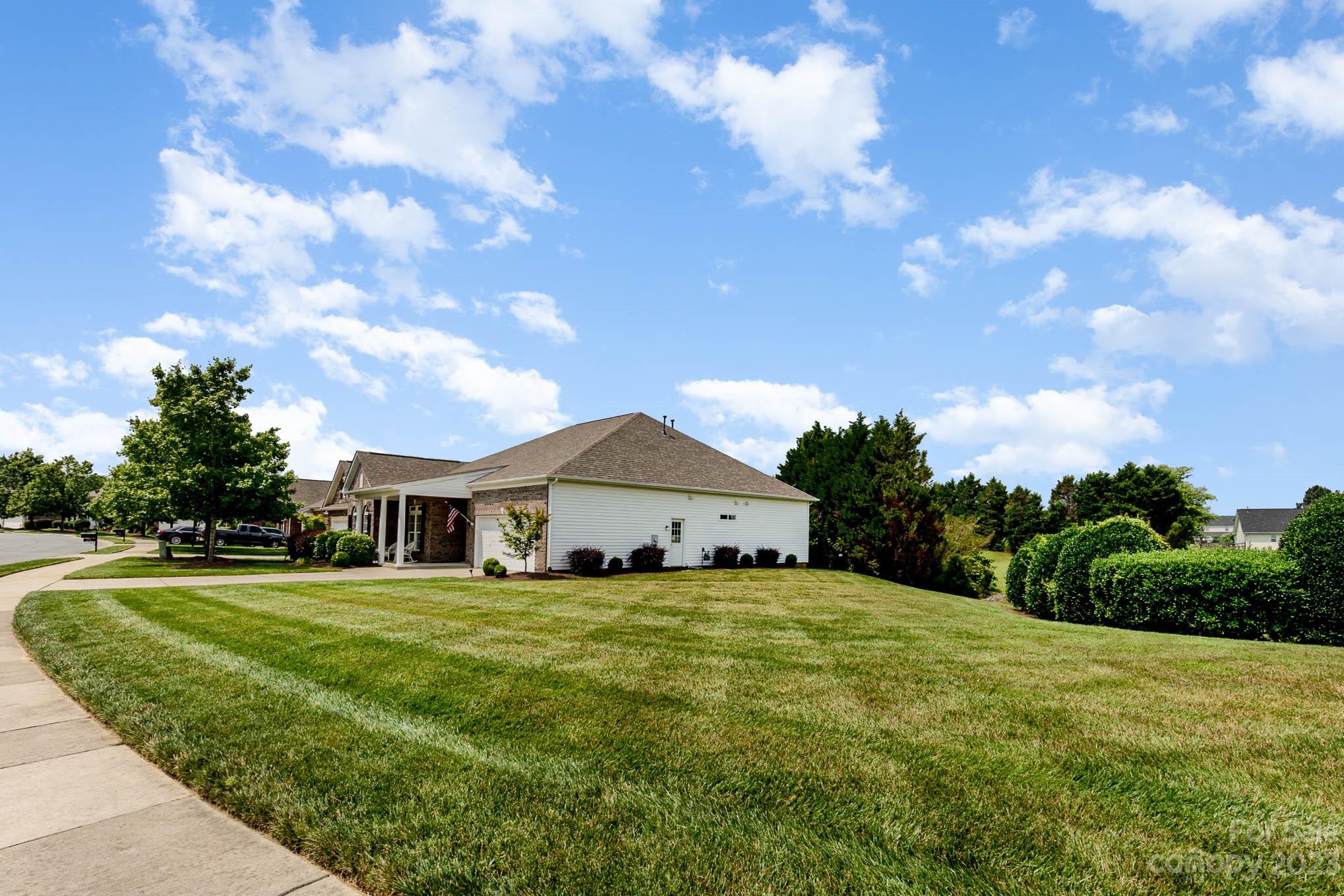 112 Pine Lake Drive Monroe, NC 28110 - Photo 4 of 37 a large house with a big yard and large trees