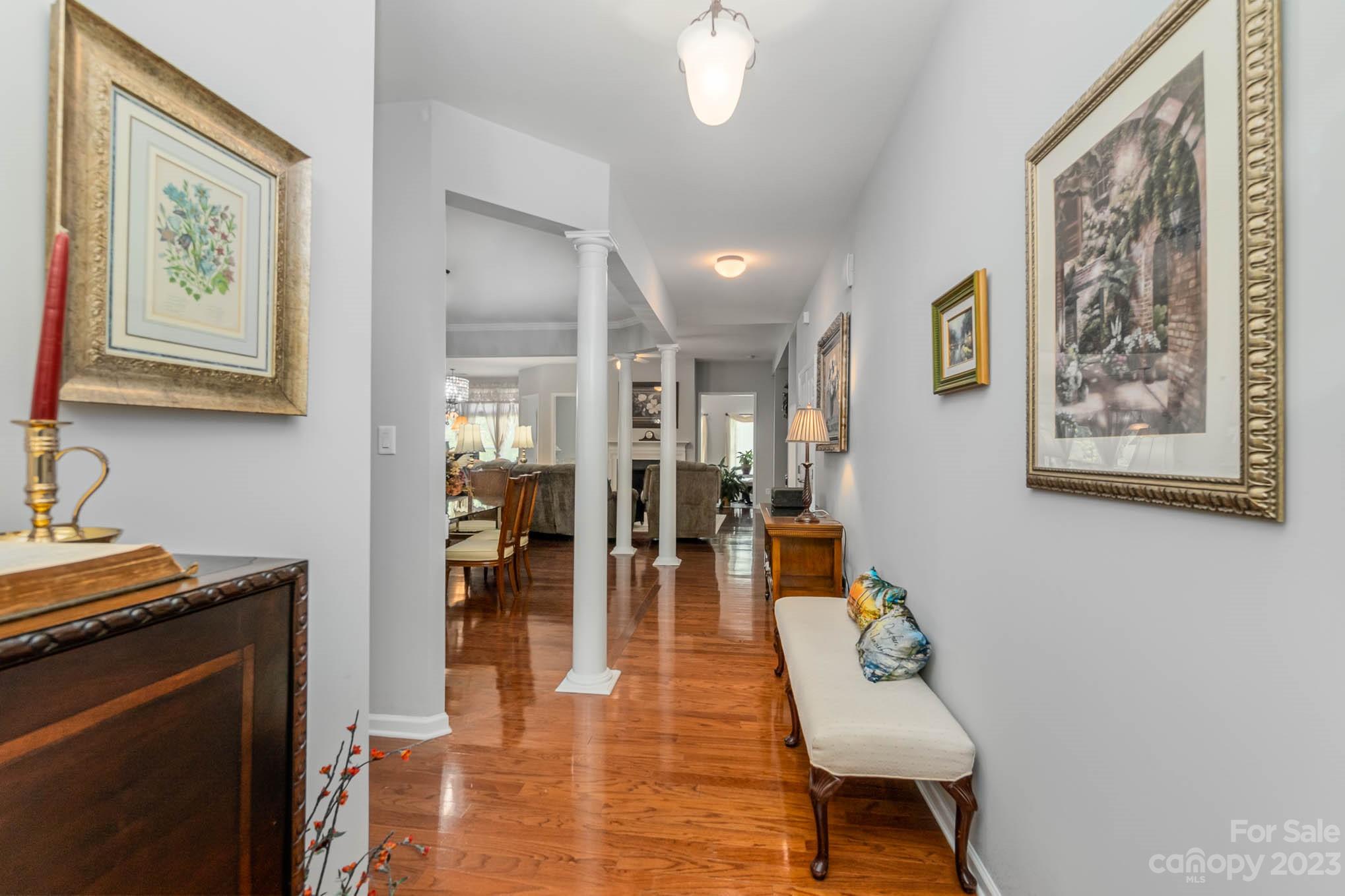 112 Pine Lake Drive Monroe, NC 28110 - Photo 7 of 37 a living room with furniture and a chandelier