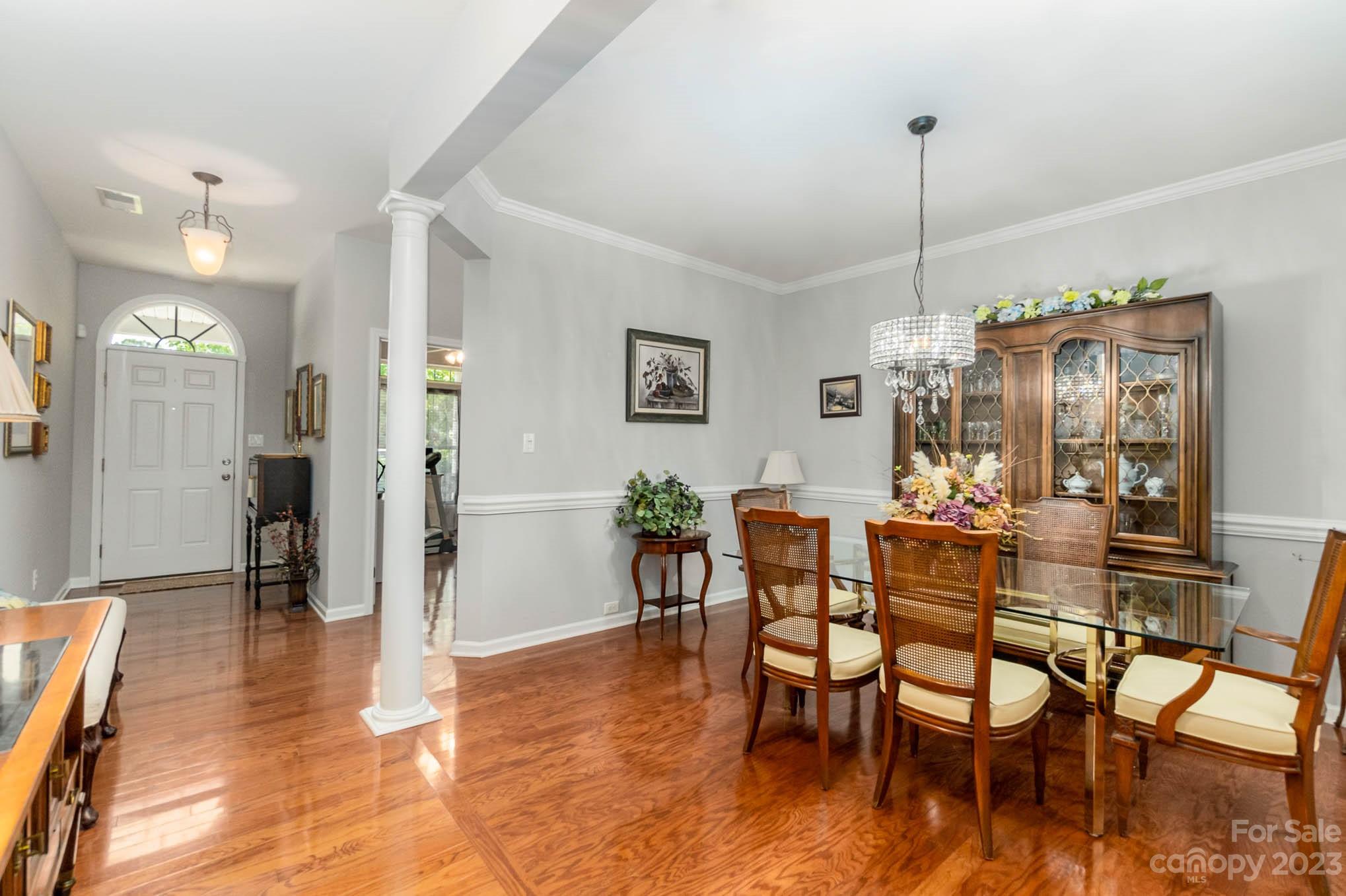 112 Pine Lake Drive Monroe, NC 28110 - Photo 9 of 37 a view of a dining room and livingroom with furniture wooden floor a chandelier