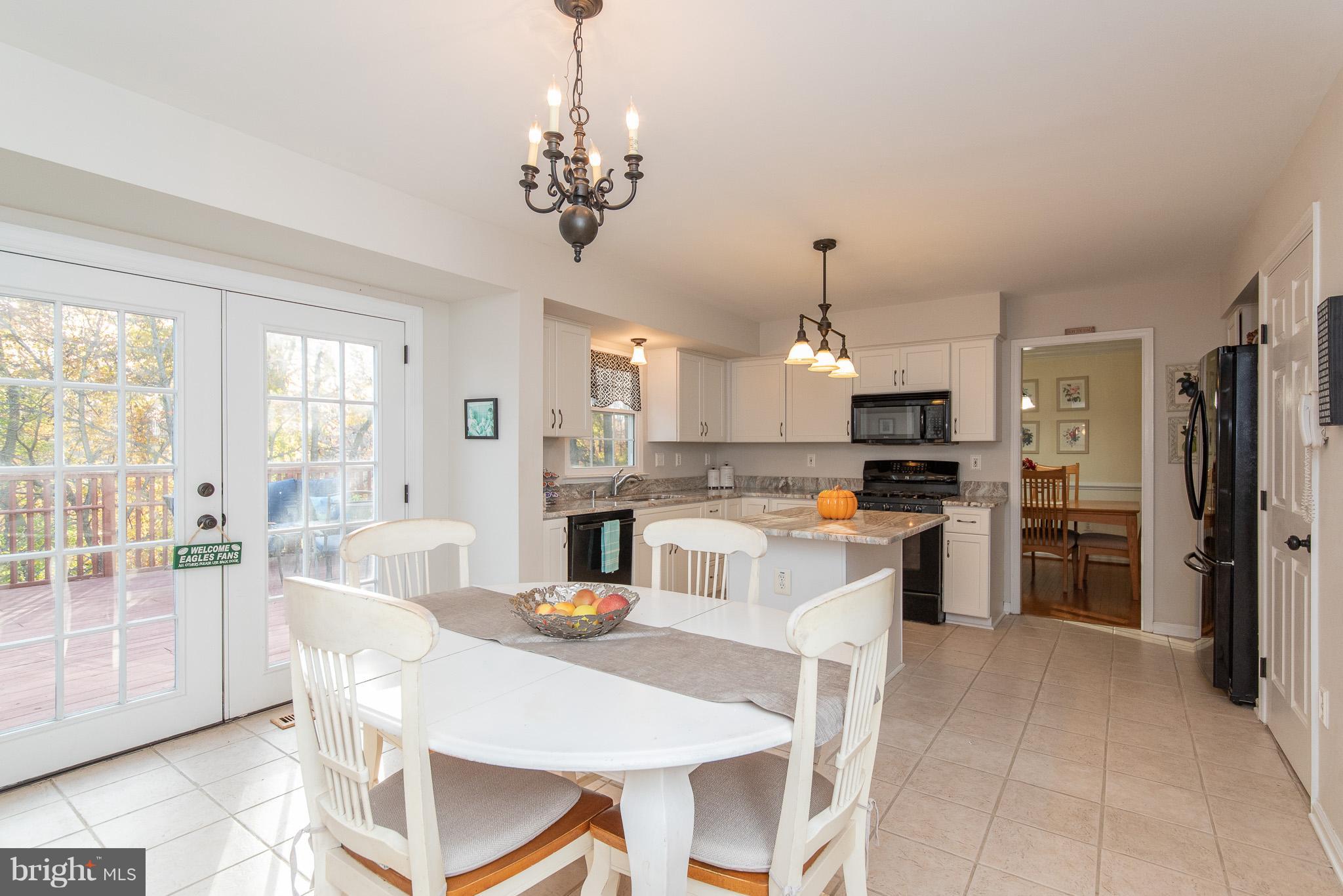 583 Henderson Road Bel Air, MD 21014 - Photo 11 of 42 a kitchen with refrigerator cabinets dining table and chairs