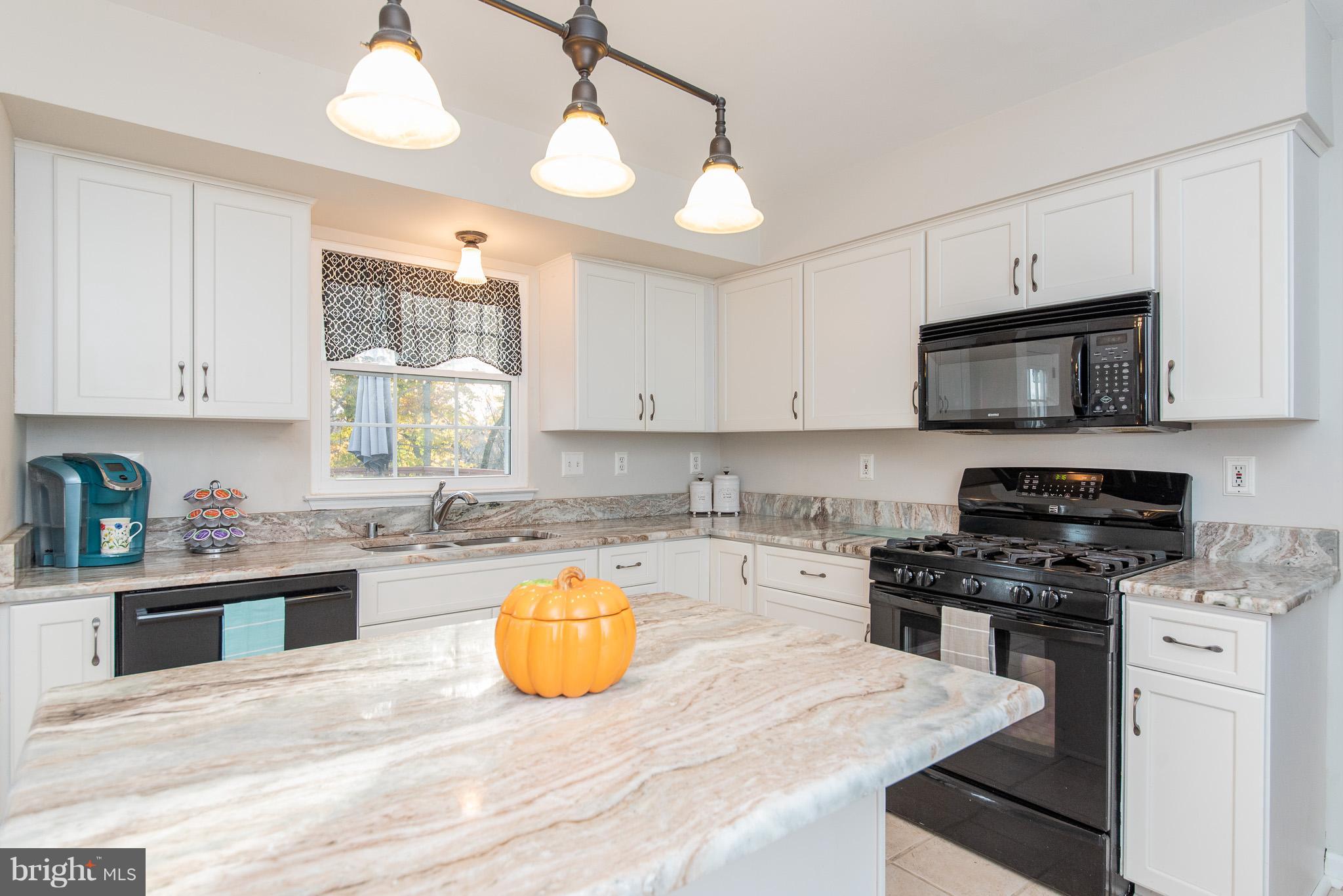 583 Henderson Road Bel Air, MD 21014 - Photo 13 of 42 a kitchen with a sink a stove a microwave and cabinets