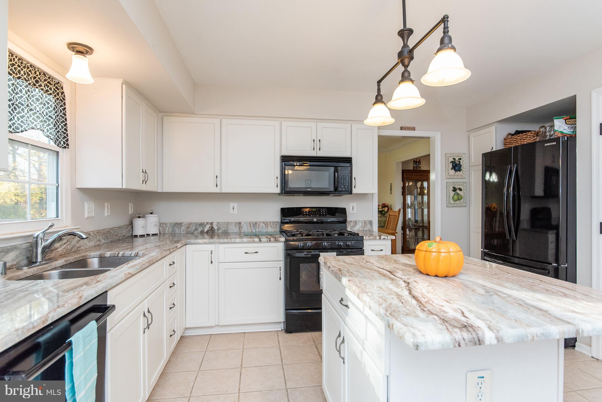 583 Henderson Road Bel Air, MD 21014 - Photo 14 of 42 a kitchen with stainless steel appliances granite countertop a sink a stove a refrigerator cabinets and living room view