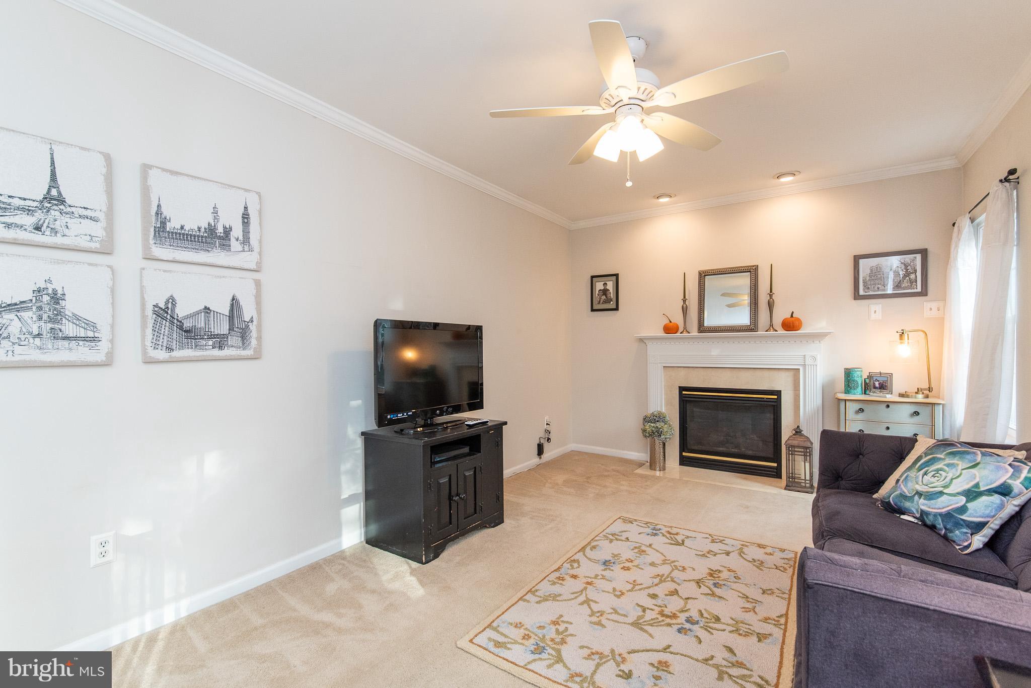 583 Henderson Road Bel Air, MD 21014 - Photo 17 of 42 a living room with furniture a flat screen tv and a fireplace